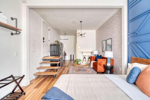 a bedroom with a bed and a living room at Stay Portland - Bright Brooklyn Studio in Portland