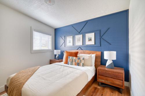 a bedroom with a blue accent wall and a bed at Stay Portland - Brilliant Brooklyn 1 Bedroom Apt in Portland