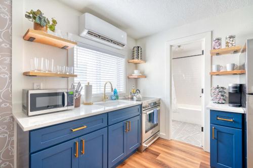 a kitchen with blue cabinets and a microwave at Stay Portland - Brilliant Brooklyn 1 Bedroom Apt in Portland