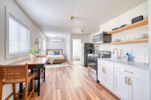 a kitchen with a dining table and a room with a bed at Stay Portland - Amazing Giant Studio in Brooklyn in Portland