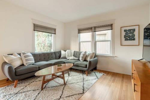 a living room with a couch and a table at Stay Portland - HeartofBuckman MidCentury Dream 86 WalkScore 3BR in Portland