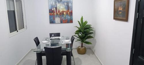 an office with a table and chairs and a potted plant at Maison de cèdre in Azrou