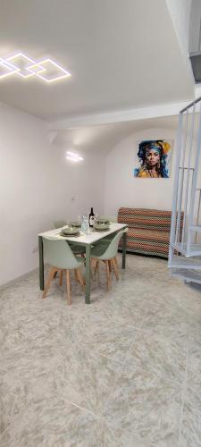 a dining room with two tables and a couch at Raggiu di Suli in Noto