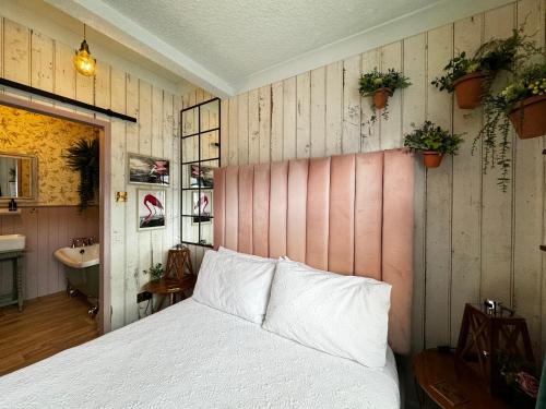 a bedroom with a white bed and a sink at The Townhouse 101 in Sandown
