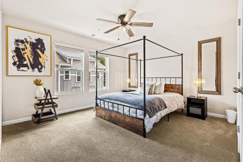 a bedroom with a canopy bed and a ceiling fan at Price Cut, New Lux Home 5 mins to Airport , 15 min to Downtown, 25 min to Buckhead with 3 beds and 3 baths in Atlanta