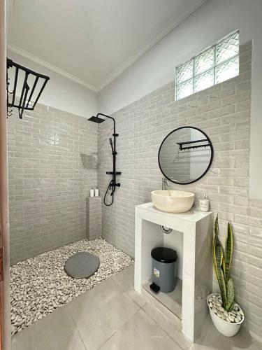 a bathroom with a sink and a mirror at Amed Happy House in Amed