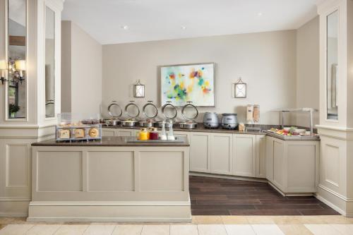 a large kitchen with white cabinets and a counter at Riverfront Hotel New Orleans in New Orleans