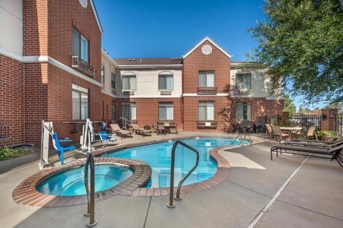 a swimming pool in front of a building at Best Western Plus Boulder Louisville in Louisville
