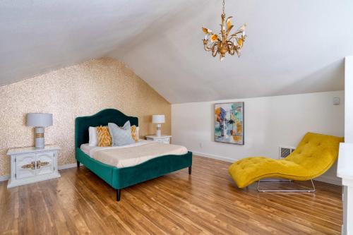 a bedroom with a green bed and a yellow chair at Stay Portland - Lively 2BR Old Hollywood Apt - 92 WalkScore in Marquam Hill