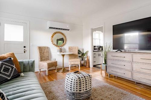 a living room with a couch and a tv at Stay Portland - BoHo Oasis in Ladd's Addition with 2 Beds in Portland