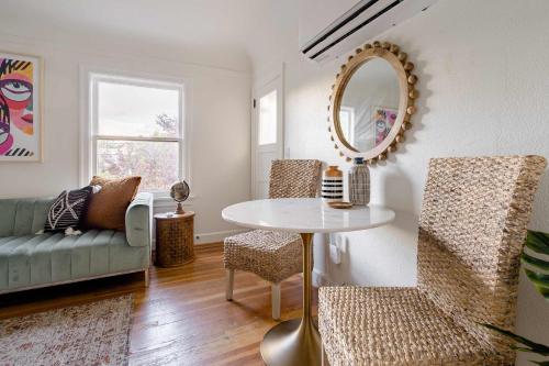 a living room with a table and a mirror at Stay Portland - BoHo Oasis in Ladd's Addition with 2 Beds in Portland