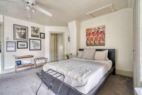 a bedroom with a large bed with a painting on the wall at Stay Portland - Sun-Filled Buckman Studio! in Portland