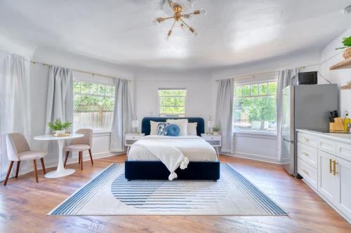 a bedroom with a bed and a table and chairs at Serene Forest Studio - Walk to Multnomah Village in Portland