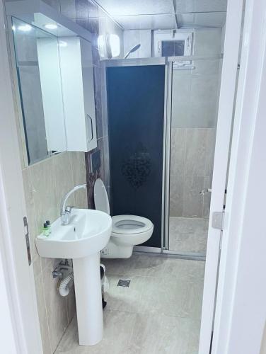 a bathroom with a toilet and a sink and a shower at Maraş Blue Life Suit in Kahramanmaraş
