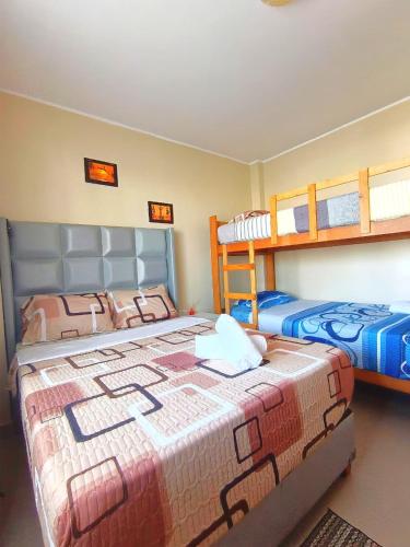 a bedroom with two beds and a bunk bed at HOSPEDAJE JOSUE - paracas in Paracas