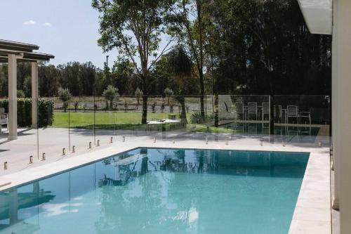 a swimming pool with blue water in a yard at Semillon Retreat in Belford