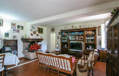 a living room with a television and a fireplace at 2 Bedroom Beautiful Apartment In Querceta in Querceta