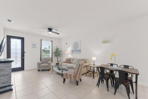 a living room with a table and chairs and a couch at Busch Garden New House in Tampa
