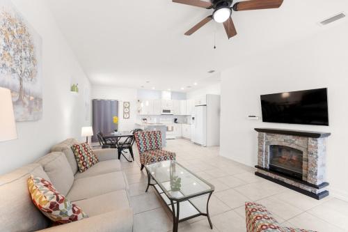 a living room with a couch and a fireplace at Busch Garden New House in Tampa