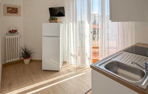 a kitchen with a white refrigerator and a sink at Nice Apartment In Montevarchi With Wifi in Montevarchi