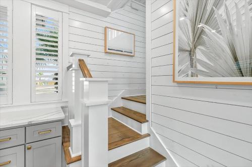 a staircase in a house with white walls and wooden floors at Sun Chaser Cottage 205 FIV-D in Port Aransas