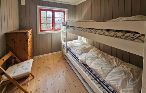 two bunk beds in a room with a window at Gorgeous Home In Eggedal With Sauna in Surteberg
