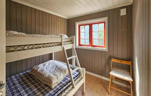 a bedroom with two bunk beds and a chair at Gorgeous Home In Eggedal With Sauna in Surteberg