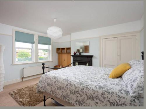 a bedroom with a bed with a yellow pillow on it at Entire three bed house in wigginton, York in York