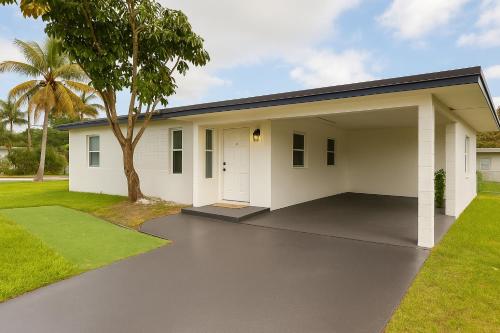 a house with a garage and a palm tree at The Awali in Miami