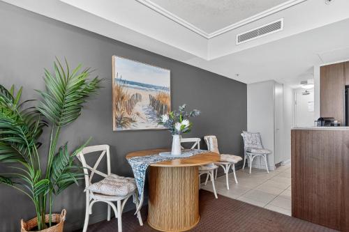 a dining room with a table and chairs at Coastal Escape with River Views in Casino Towers in Brisbane