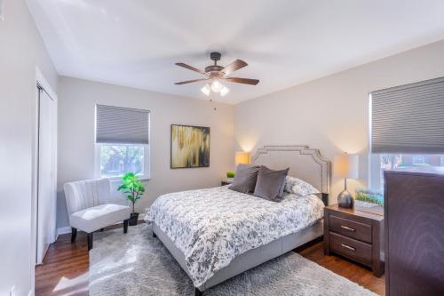 a bedroom with a bed and a ceiling fan at Designer 3BR Ranch Home near Clayton & Wash U in University City