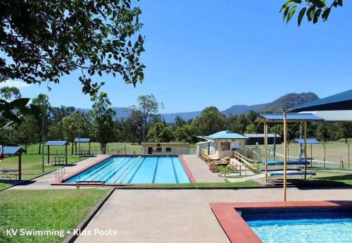 a large swimming pool with a pavilion at Calla Vale - 3 Bed House Incredible Valley Views in Kangaroo Valley