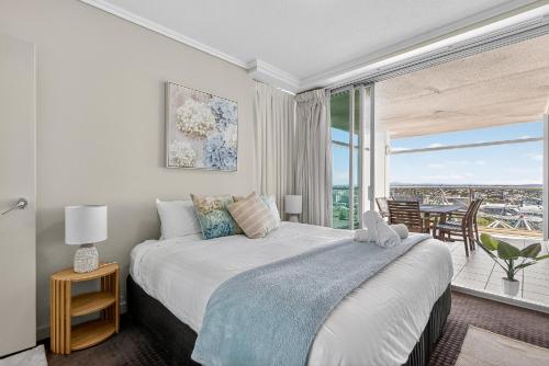 a bedroom with a bed and a large window at Coastal Escape with River Views in Casino Towers in Brisbane