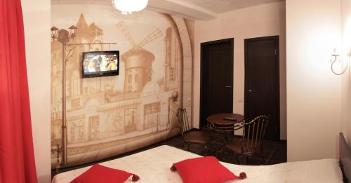 a bedroom with a mural of a building on the wall at Agio Hotel in Ufa