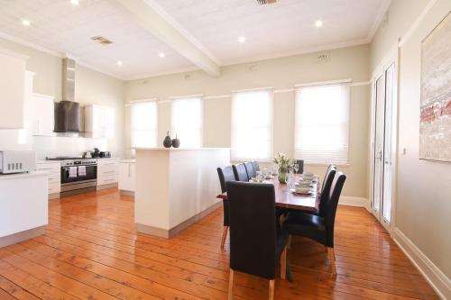a kitchen and dining room with a table and chairs at Waterviews - Hidden Gem in CBD - Sleeps 10 in Wagga Wagga