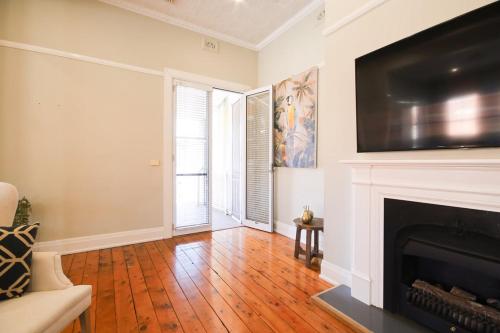 a living room with a fireplace and a television at Waterviews - Hidden Gem in CBD - Sleeps 10 in Wagga Wagga