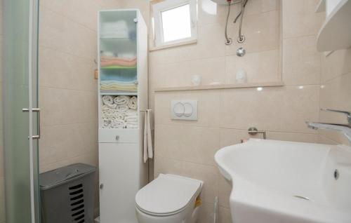 a small bathroom with a toilet and a sink at Family friendly house with a swimming pool Grab, Zagora - 15208 in Grab