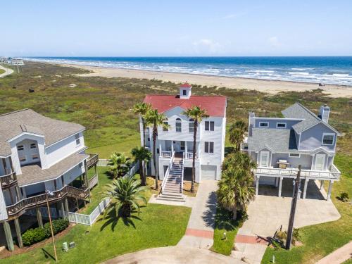 an aerial view of a house and the beach at Breakers Pointe in Galveston
