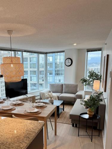 a living room with a couch and a table at The Altitude with Mountain & City Views, Pool & Hot Tub in Vancouver