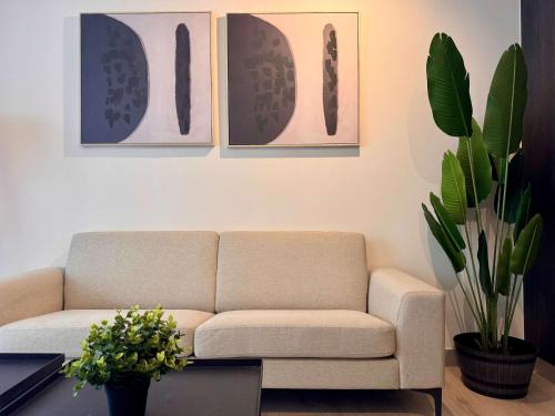 a living room with a couch and some pictures on the wall at Nuevo y Comodo excelente ubicacion in Santiago