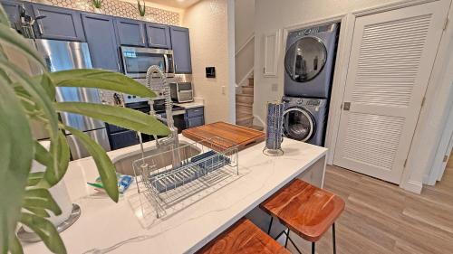 a kitchen with a dish drying rack on a counter at Villas at Seven Dwarfs Resort - Near to Disney in Kissimmee