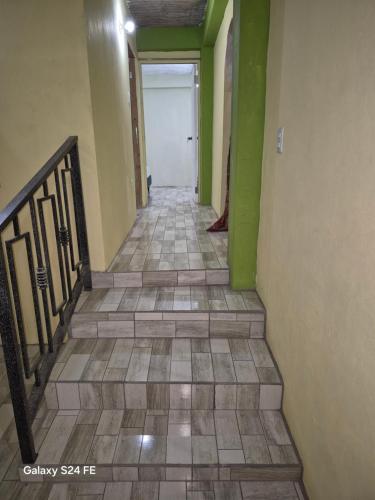 a hallway with a tile floor and a white door at Casa De Morrison-3 bedroom in Plymouth