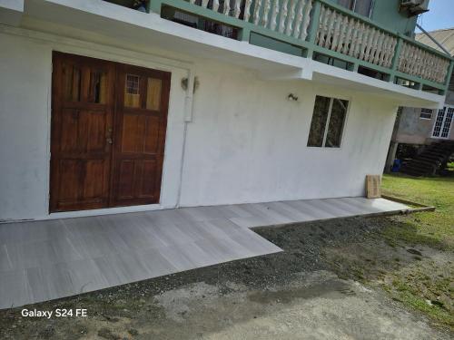 a house with a wooden door and a balcony at Casa De Morrison-3 bedroom in Plymouth