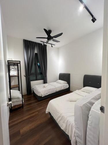 a bedroom with two beds and a ceiling fan at Sunway Onsen beautiful view 4-6pax in Tambun