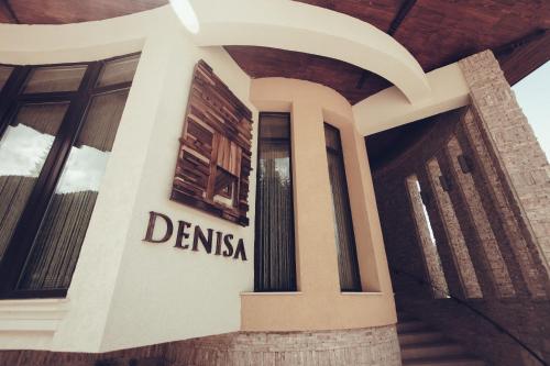 a sign on the side of a building at Denisa Boutique in Poiana Brasov