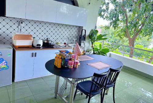 a kitchen with a blue table and chairs in a kitchen at Gem's House 1- Balcony with Riverside View in Ho Chi Minh City