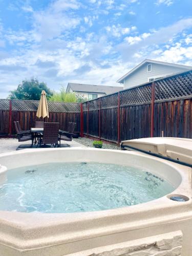 a jacuzzi tub in a yard with a patio at Game Night Meets Wine Country Elegance in Santa Rosa
