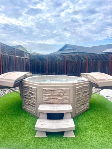 a hot tub in a yard with two chairs at Game Night Meets Wine Country Elegance in Santa Rosa