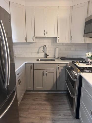 a kitchen with white cabinets and a sink at So sweet so stylish in Elizabeth