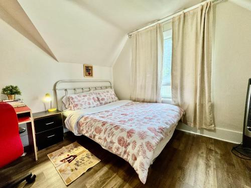 a small bedroom with a bed and a window at Private Room with Shared Amenities 10 Minutes to Airport and Walking Distance to Bus Station in Seattle